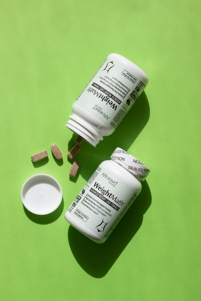 Weight management vitamin bottles with tablets on a vibrant green background for healthy living.